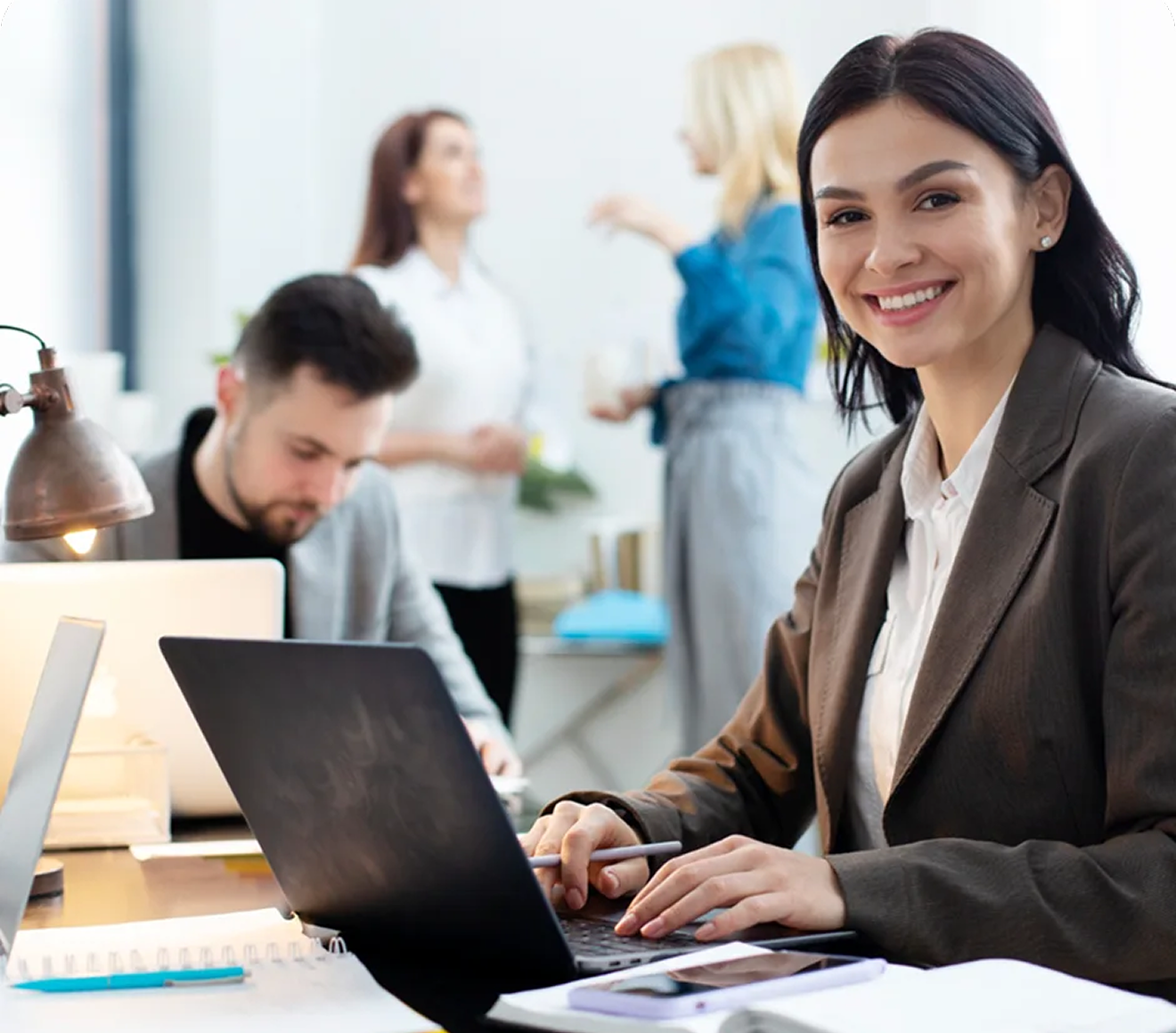 Students collaborating around a laptop